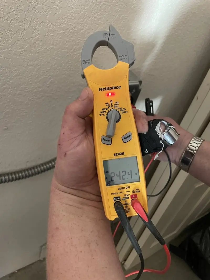 Voltage testing with clamp meter during Whole House Surge Protector in Cortland